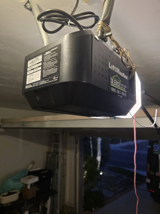 LiftMaster chain-drive garage door opener head mounted on the ceiling rail