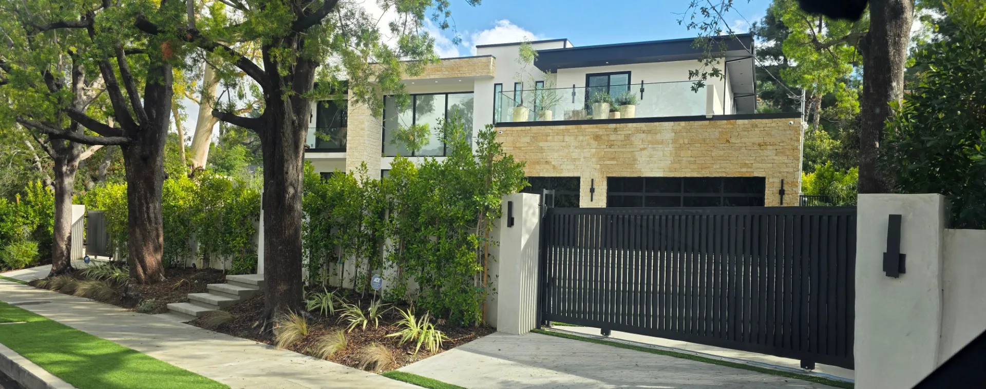 SGD Service Areas Review v2 7 Encino. Vertical-slat gate with columns, black-frame black-glass garage door, intercom system, All-O-Matic gate motor.