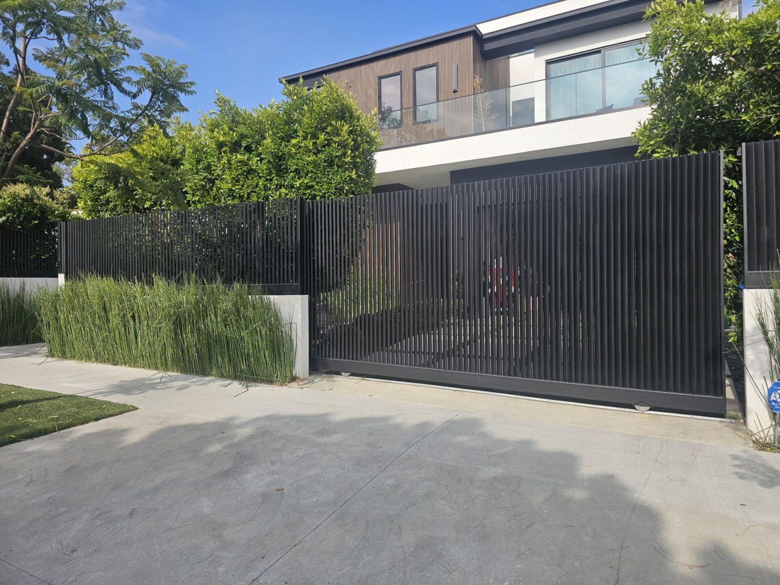 SGD Services Review v1 6 West Hollywood. Sliding gate, fence above the wall, pedestrian gate, DoorBird intercom system, block wall with smooth stucco.