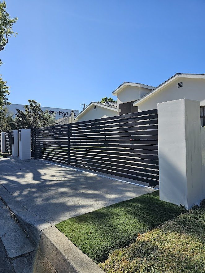 SGD Services Review v1 5 Sherman Oaks. Concrete columns, smooth stucco, intercom system, sliding gate, horizontal-slat fence.