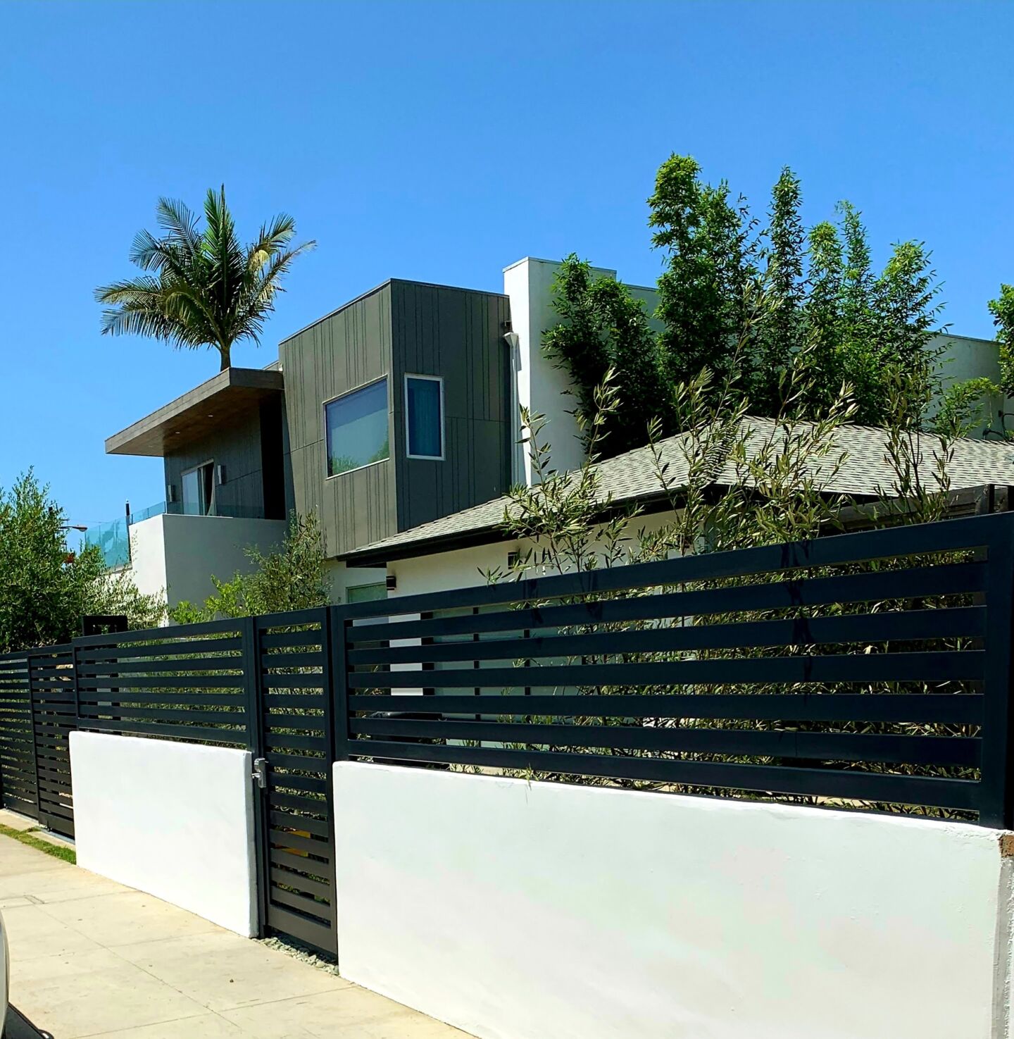 SGD Service Areas Review v2 5 Culver City. Smooth stucco block wall, horizontal-slat metal fence, telescoping gate with pedestrian gate.