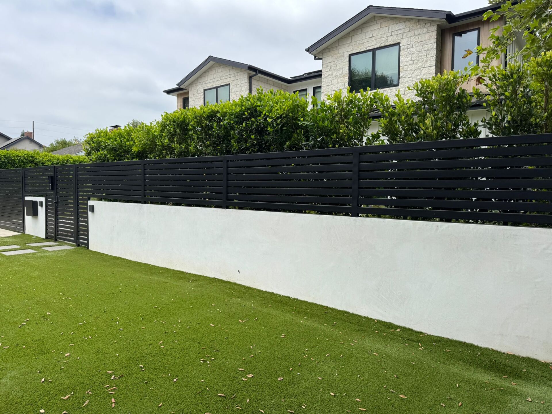 SGD Service Areas Review v2 4 North Hollywood. Smooth stucco block wall, horizontal-slat fence, double swing gate, LiftMaster motor, intercom system.