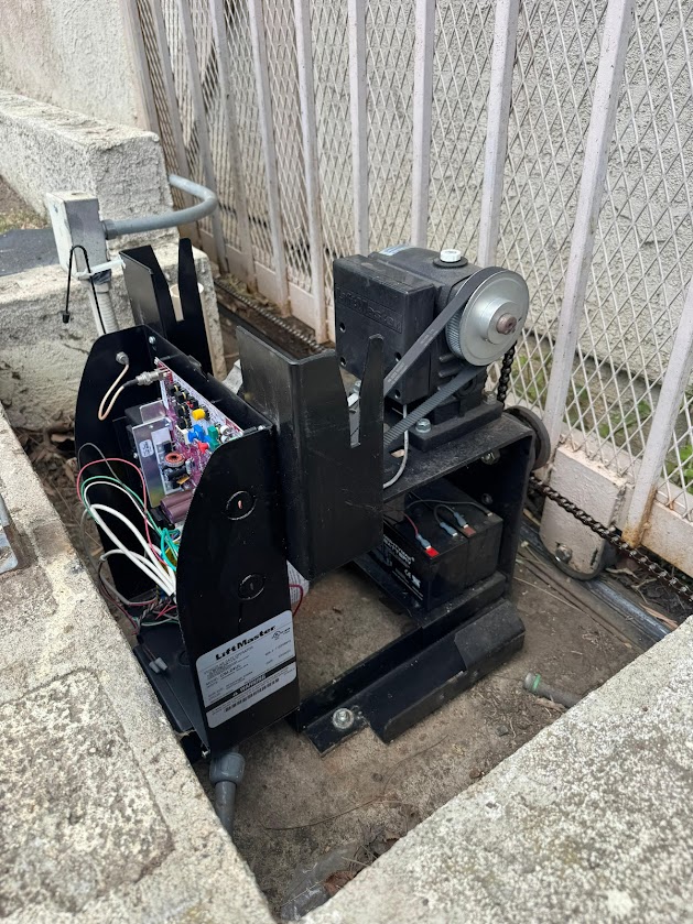LiftMaster gate operator with the cover removed, showing the motor, gearbox, control board and the LiftMaster data plate